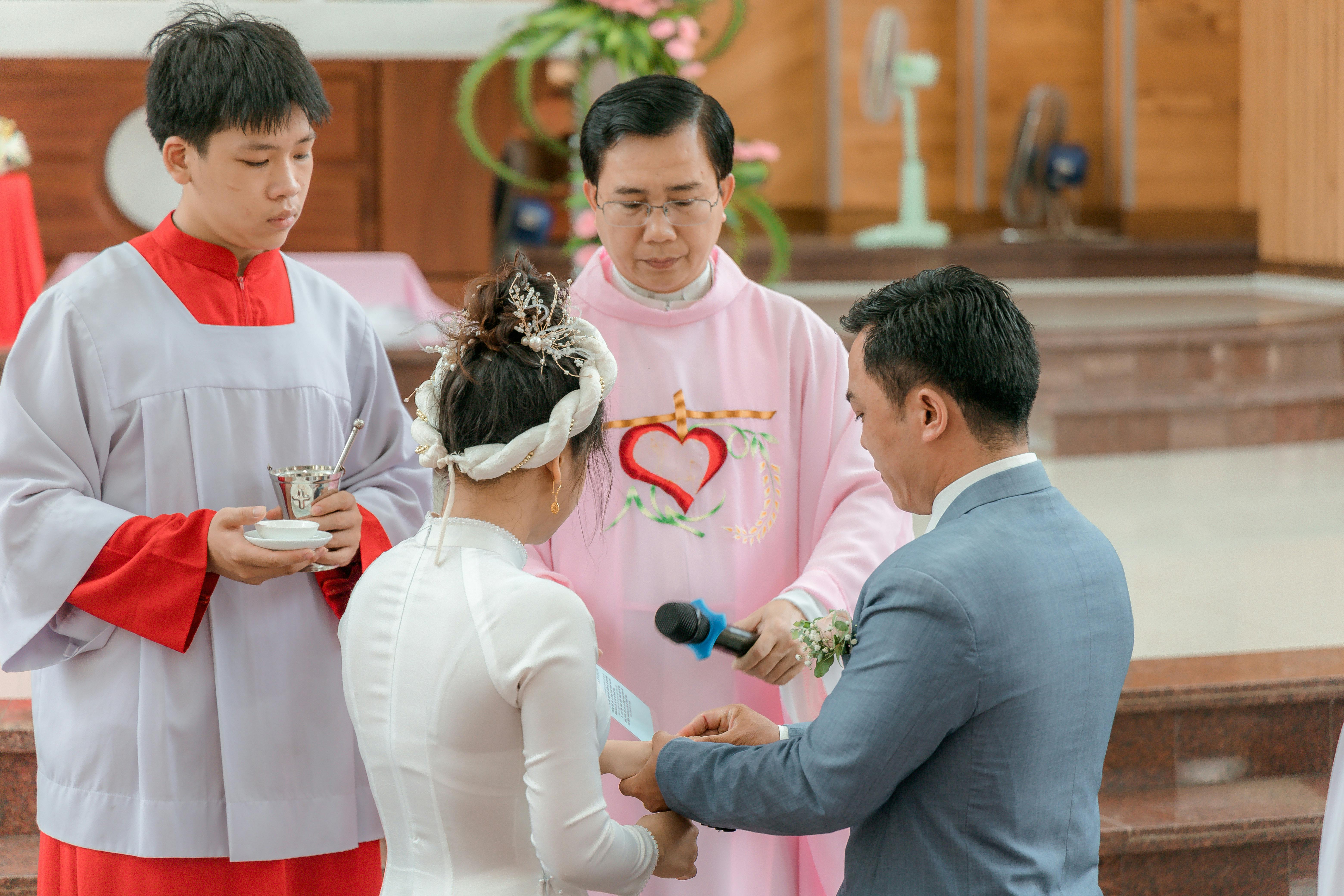 A couple exchanging vows in a traditional Christian wedding ceremony inside a church.