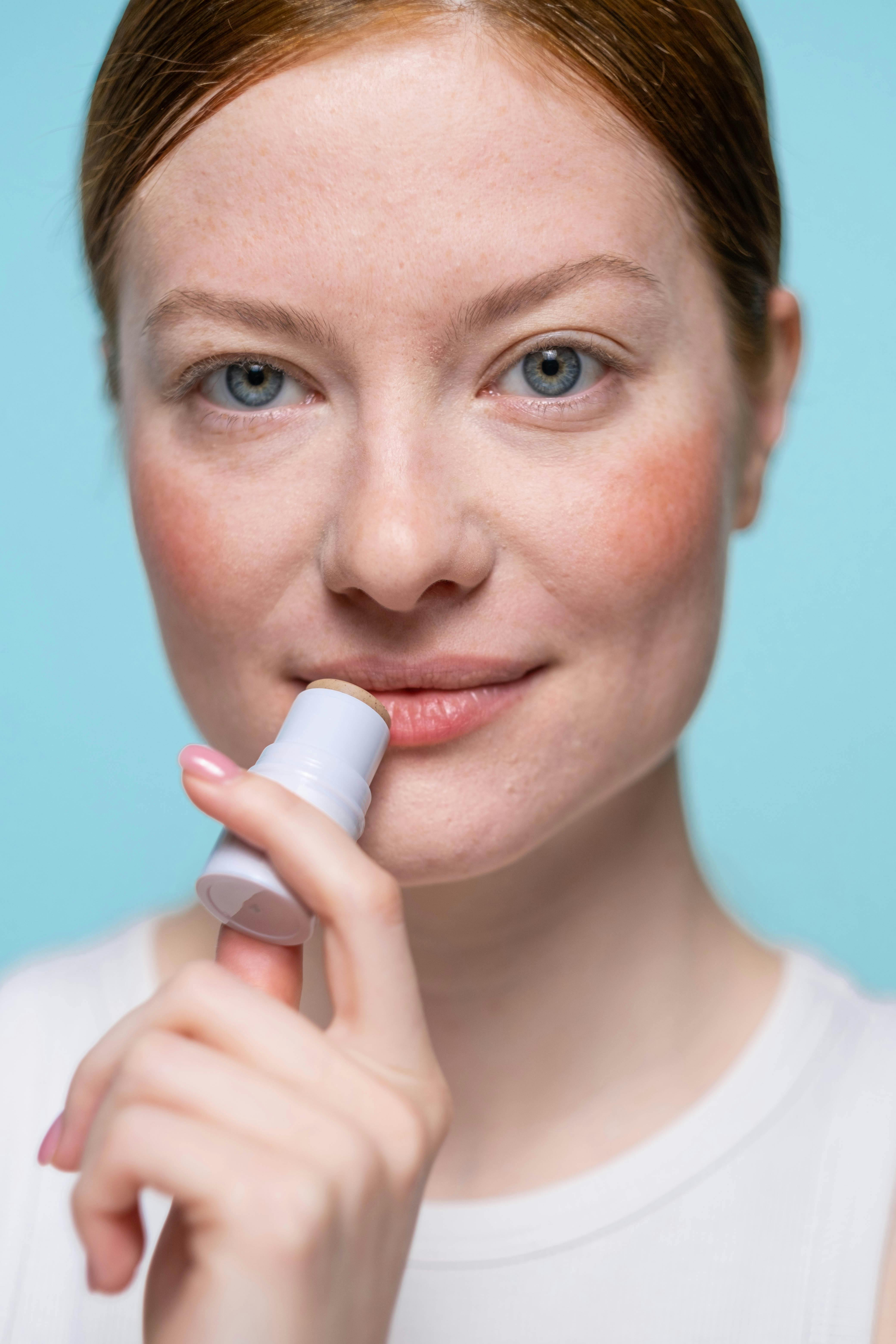 Woman Applying Lip Balm · Free Stock Photo