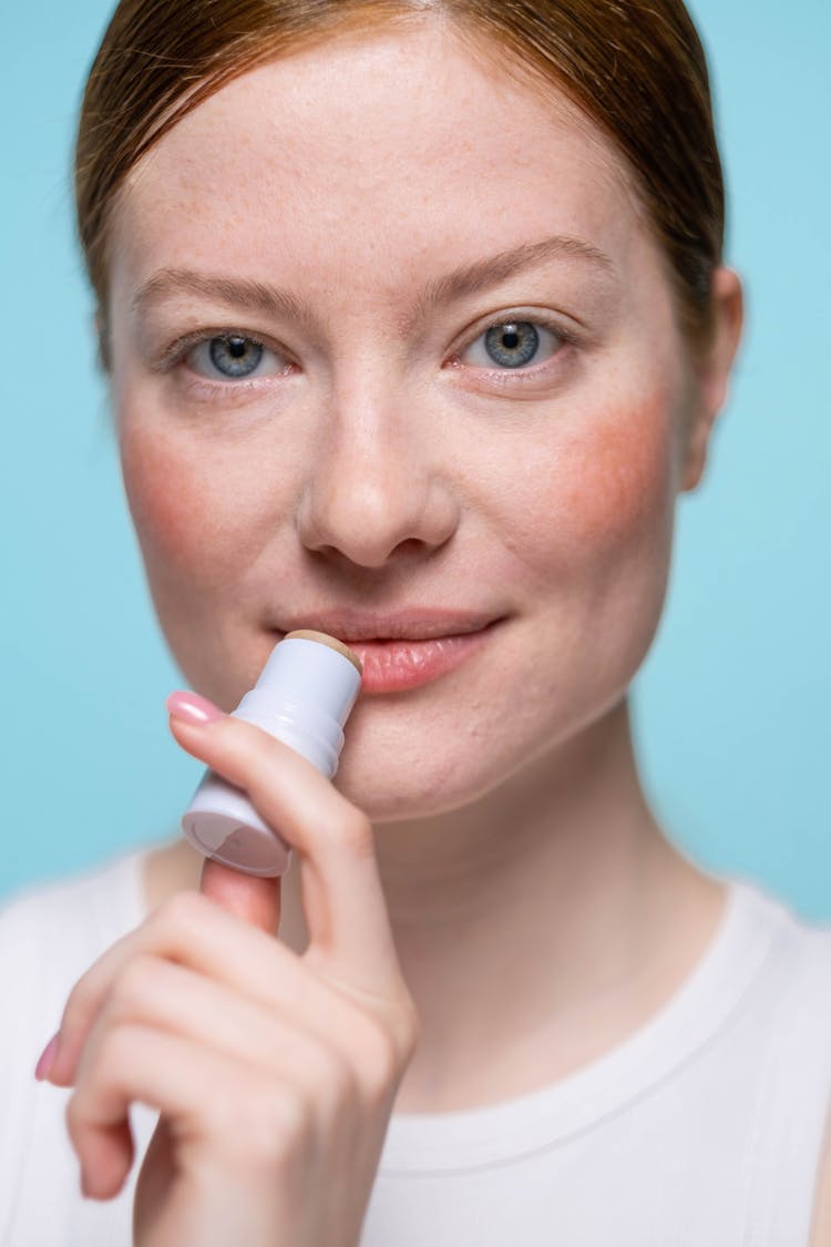 Woman Applying Lip Balm