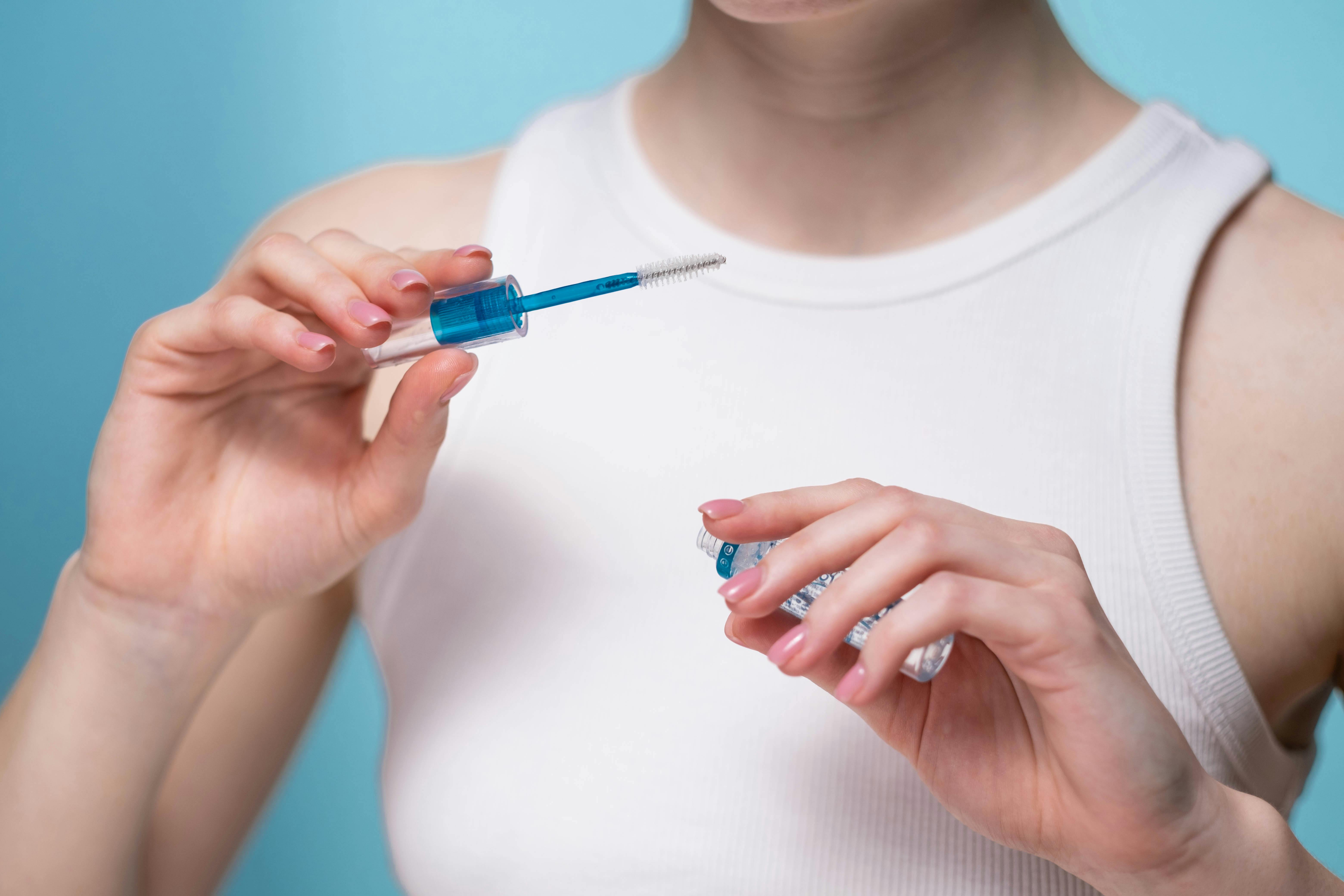 Woman in Blue Shirt Holding Blue Pen