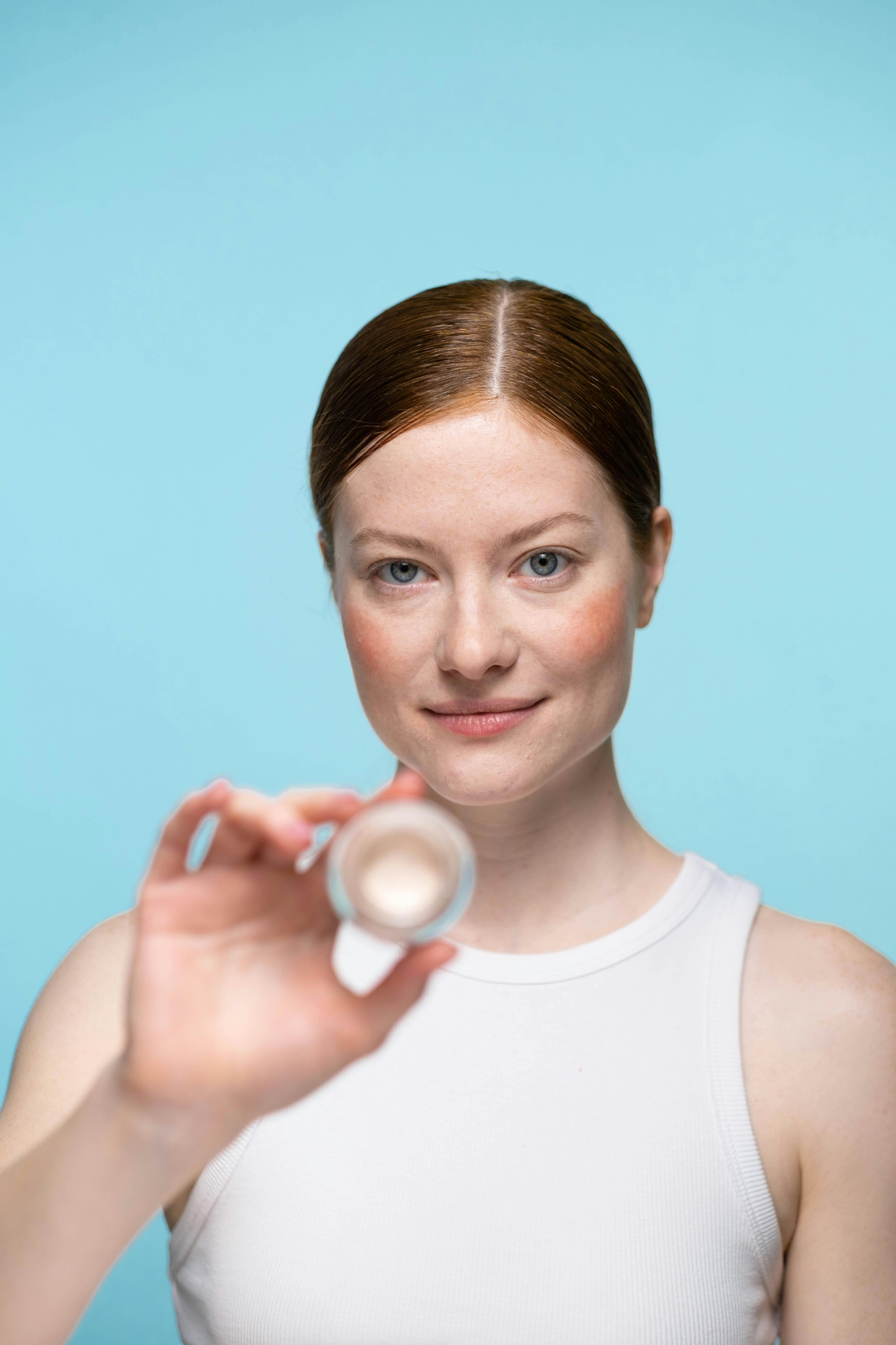 Woman in White Tank Top Holding White Round Ornament