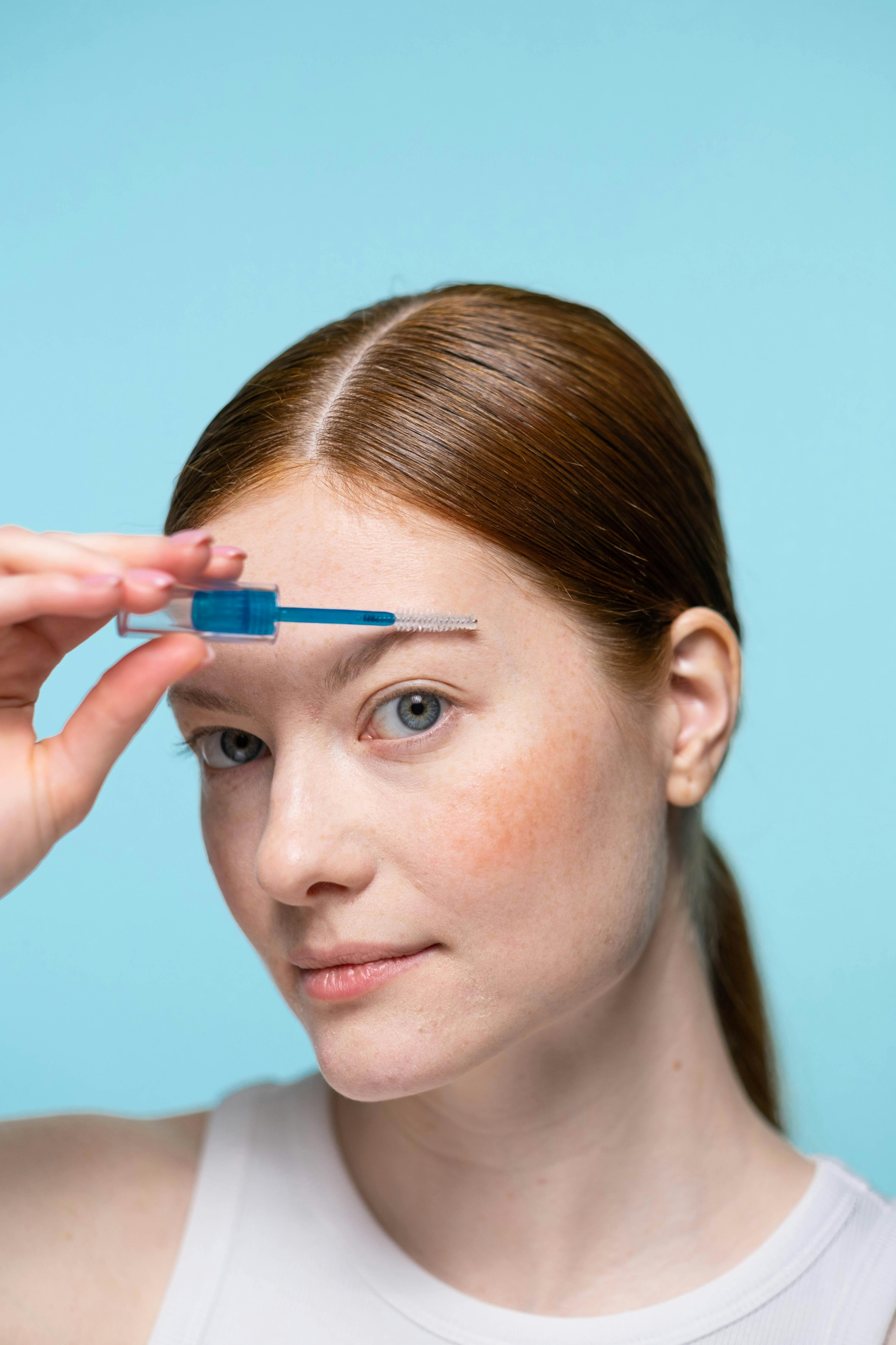 Woman With Blue Eyes Holding Blue Pen