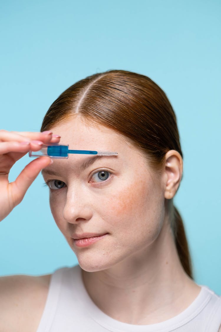 Woman Applying Eyebrow Makeup