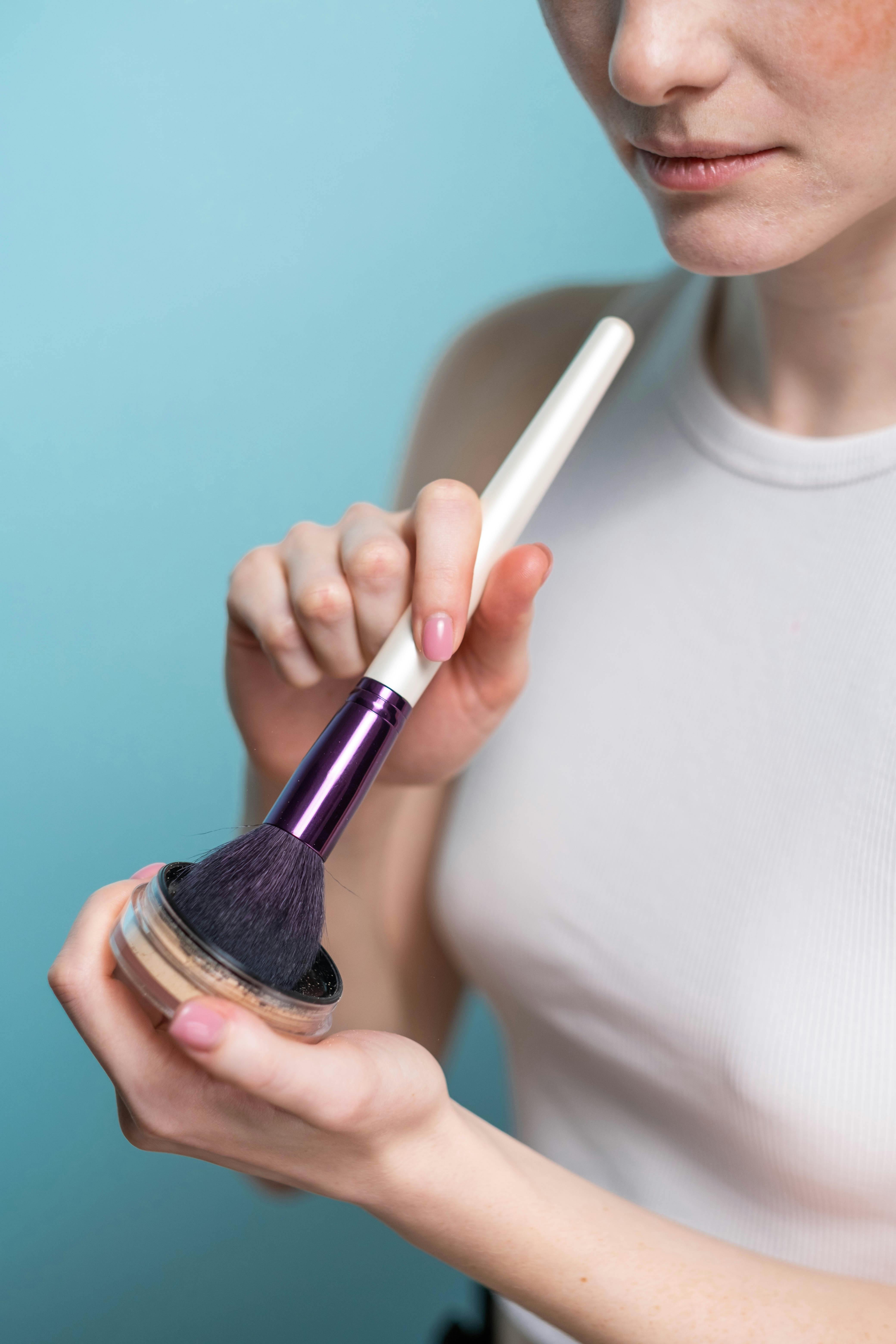 crop photo of woman holding blush on