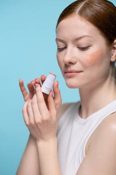 A young woman appreciates the quality of lip balm in a bright studio setting.