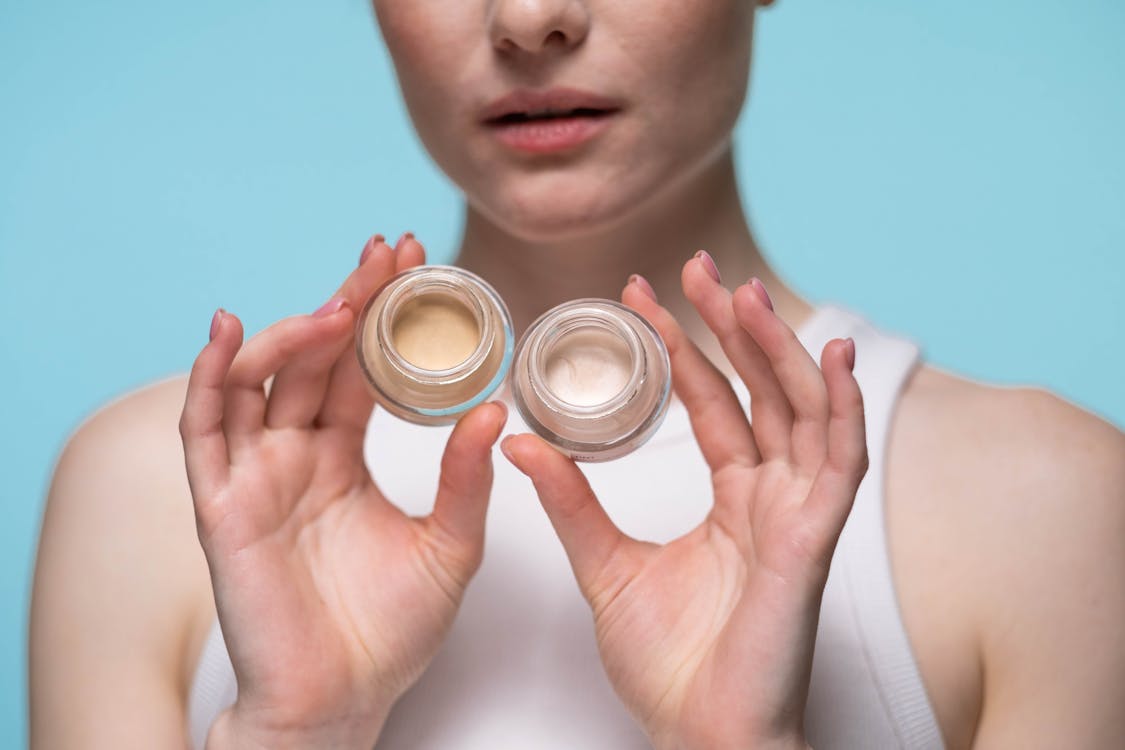 Free Crop Photo Of Woman Holding Cosmetic Products Stock Photo