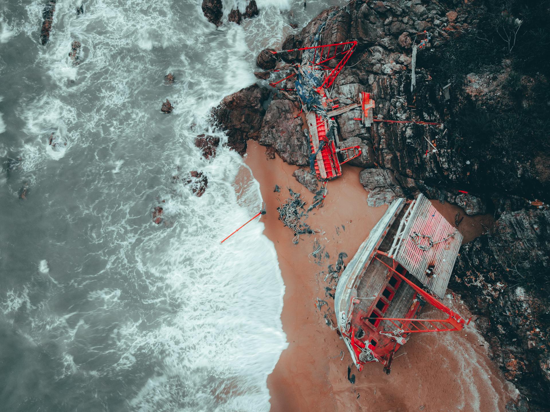 Exploratory aerial view of a shipwreck on the rocky shores of Chukai, Terengganu, Malaysia.