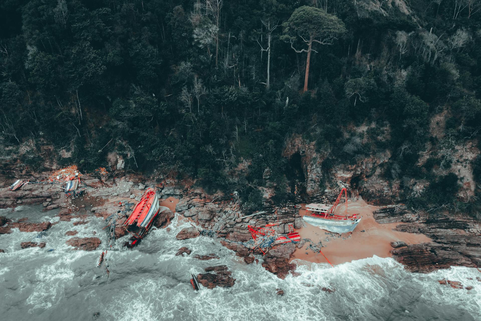 Dramatic aerial shot of an abandoned shipwreck along the coast of Chukai, Terengganu, Malaysia.