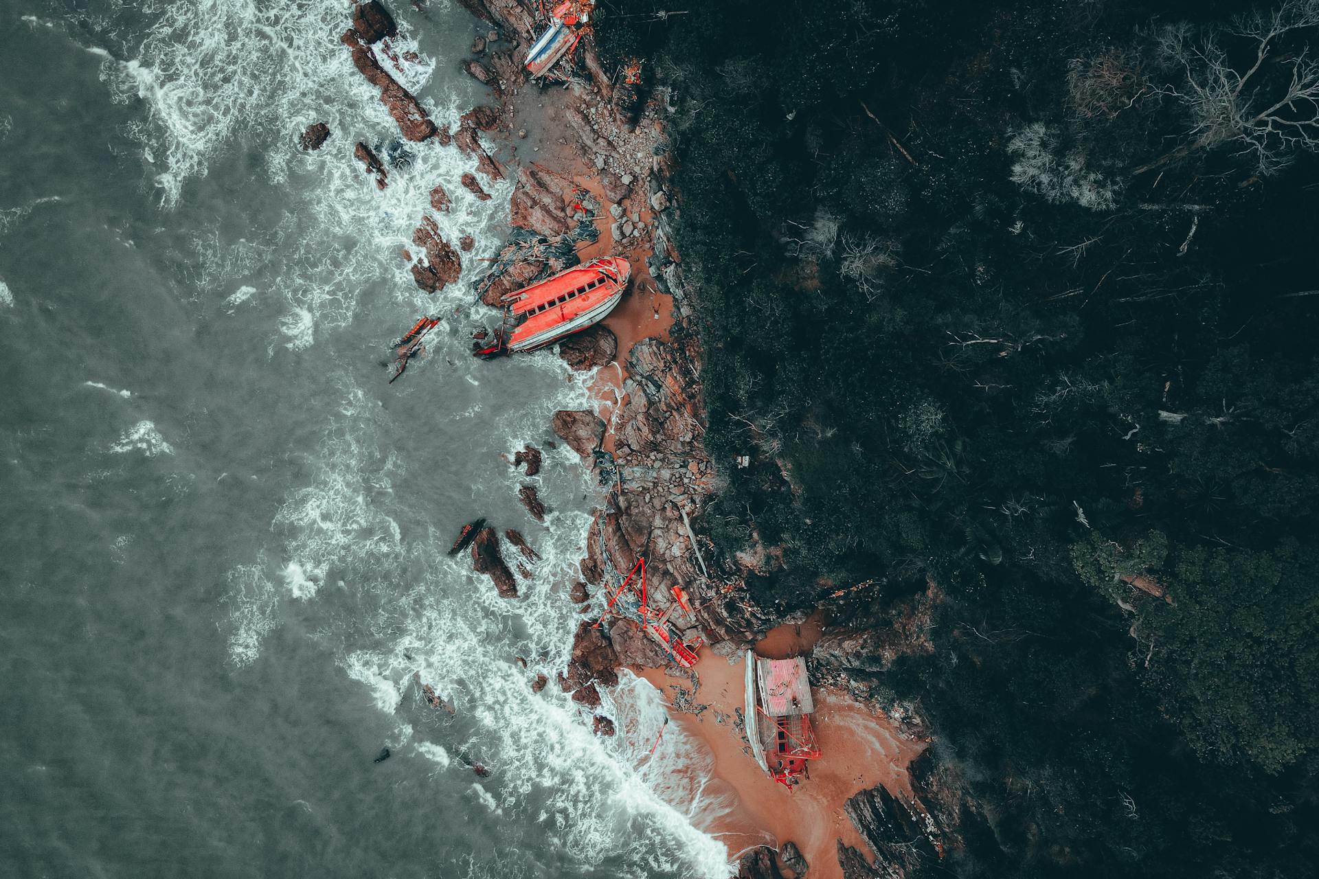 Orange Boat Crashed on the Rocky Shoreline