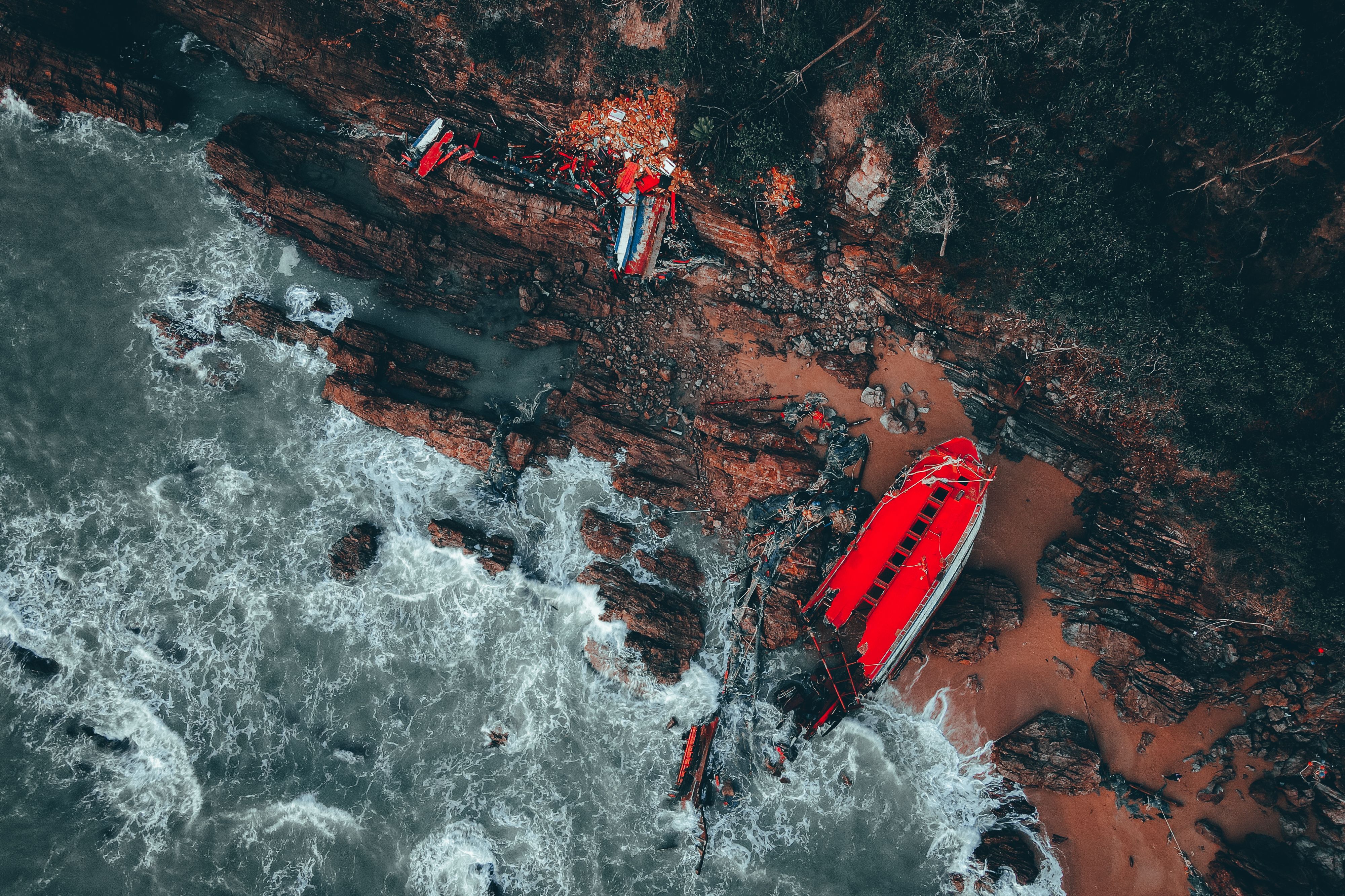 Aerial View of a Broken Shipwreck Lying on a Rocky Shore · Free Stock Photo