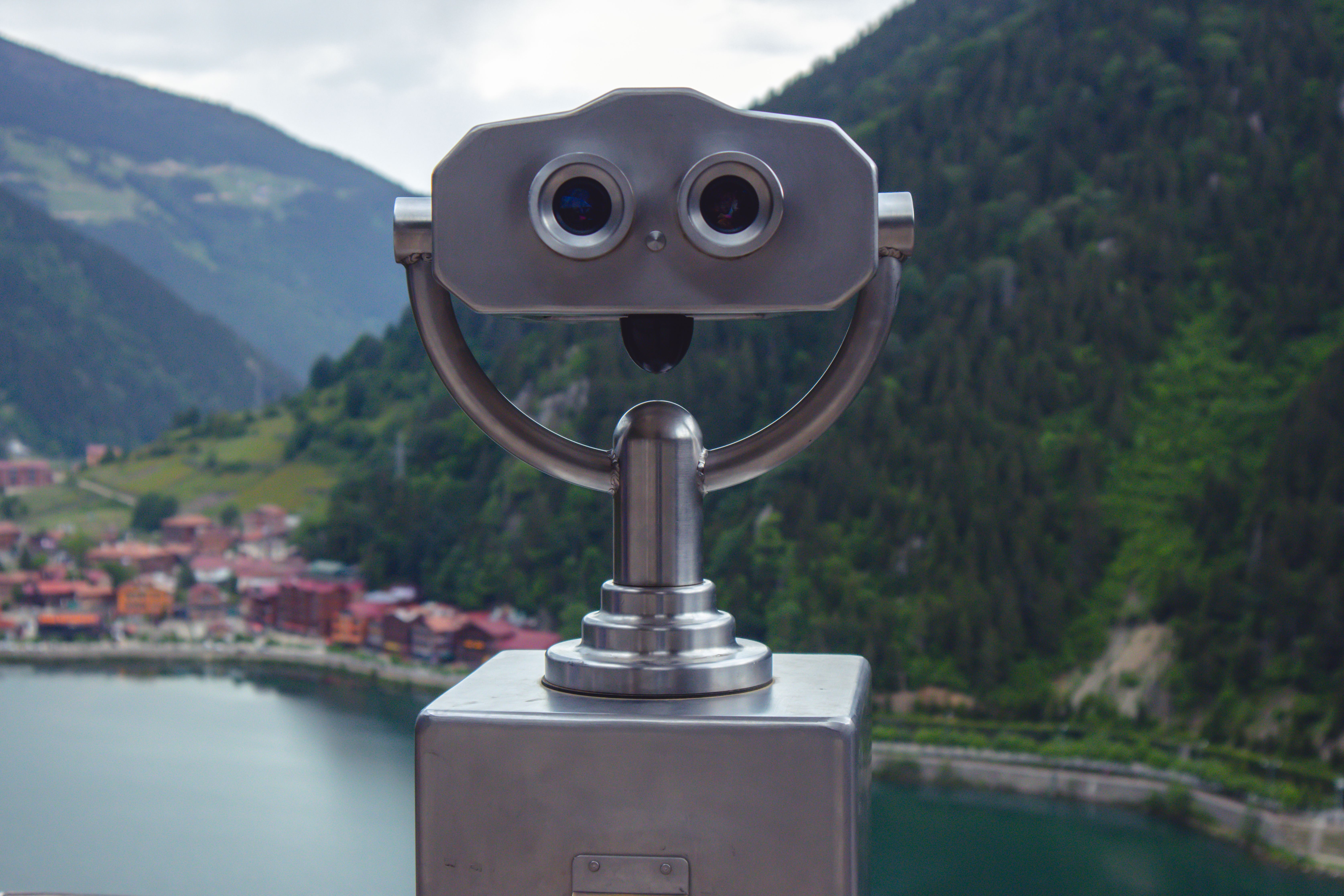 Coin-operated telescope viewing Uzungöl Lake and surrounding mountains in Trabzon, Turkey.