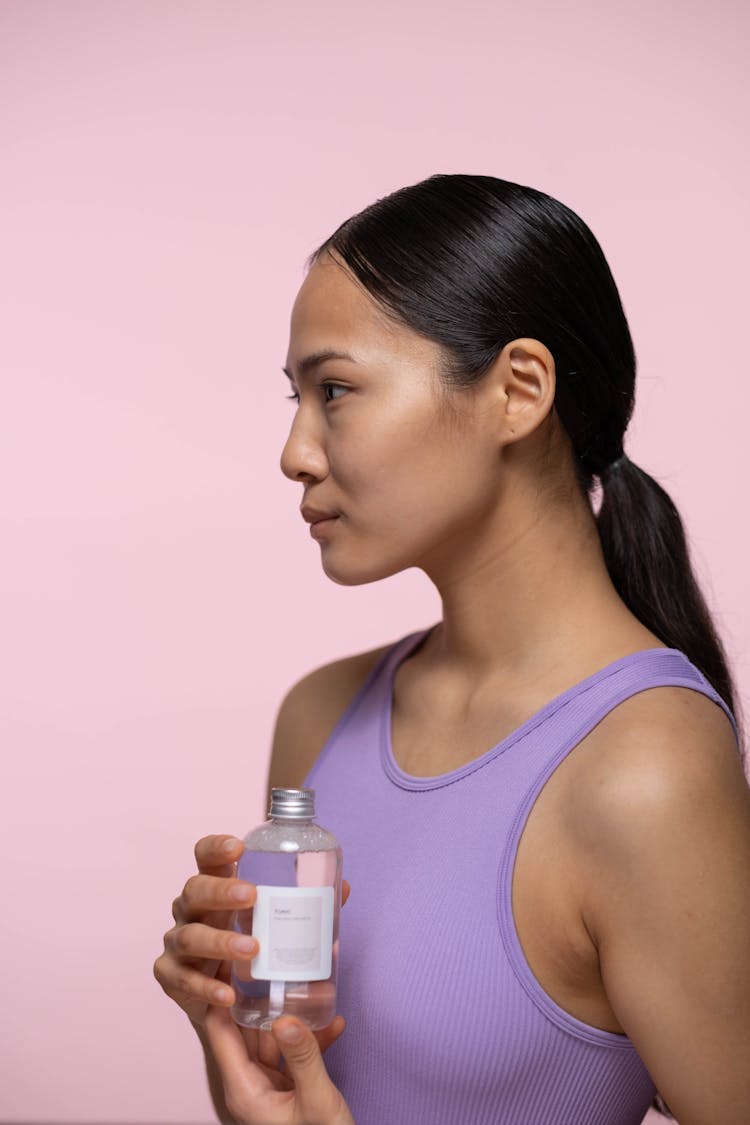 Woman Holding A Bottle Of Tonic