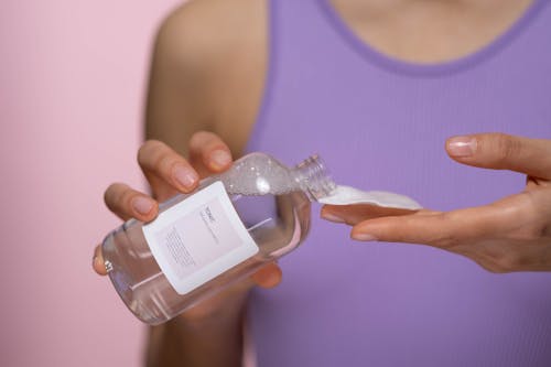 Woman Holding Clear Bottle Of Facial Tonic