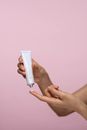 Person Holding A Skin Care Cream In White Tube