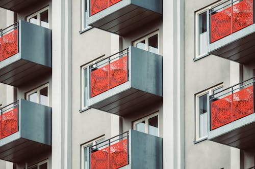 Free White and Orange Concrete Building with Balconies Stock Photo