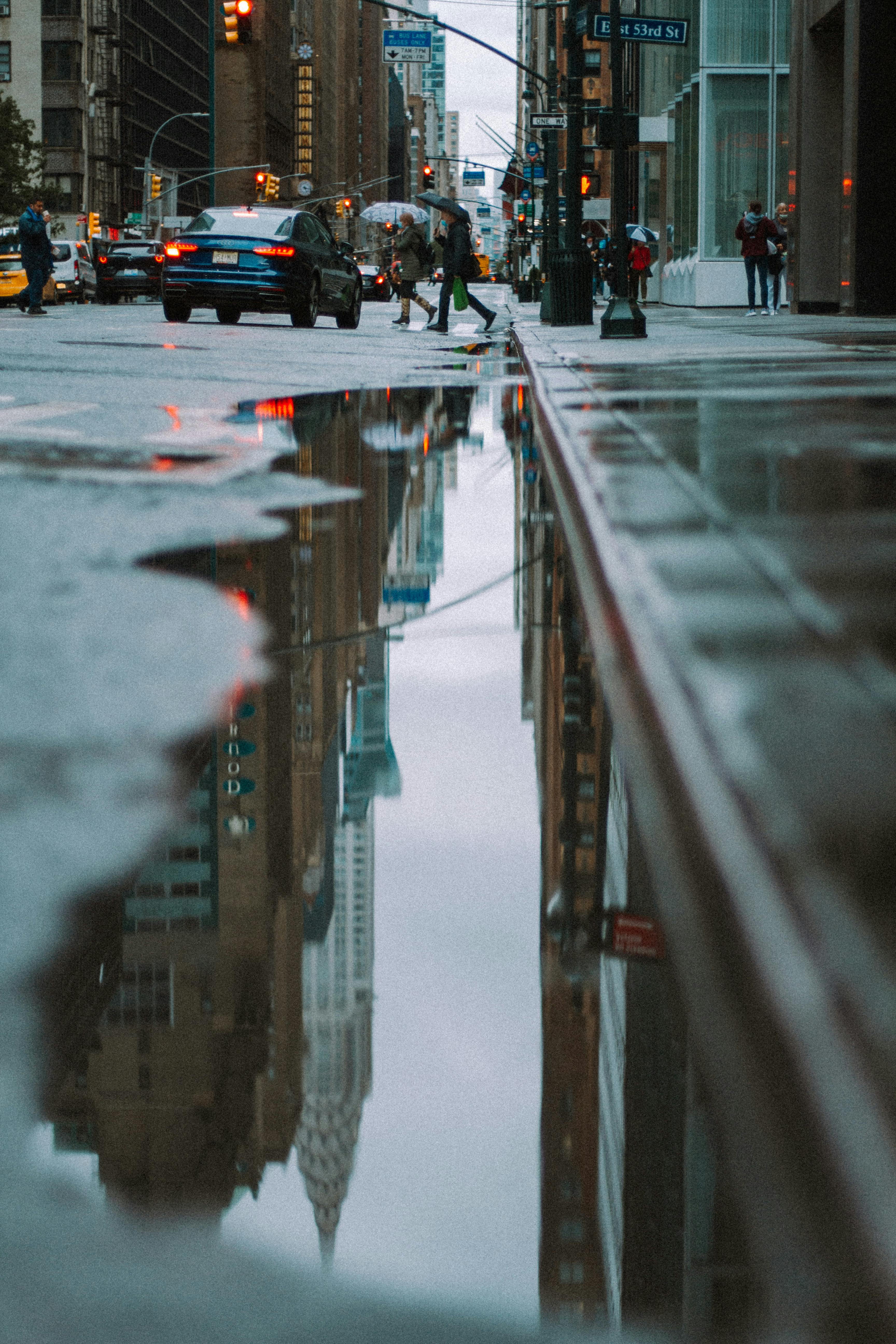 wet asphalt road in city in daytime