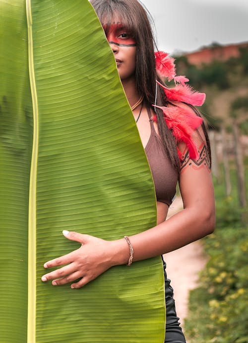 Free Woman in Brown Brassiere in Front of Banana Leaf Stock Photo