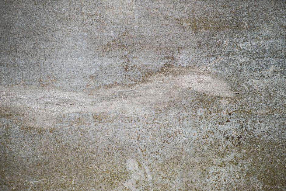 Gray concrete wall texture with unique patterns, ideal for backgrounds and design work.