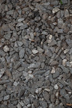 Close-up view of scattered gravel stones, perfect for background use.