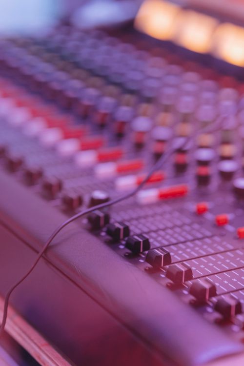 Free Close-up of an audio mixer with knobs and sliders, ideal for sound engineering context. Stock Photo