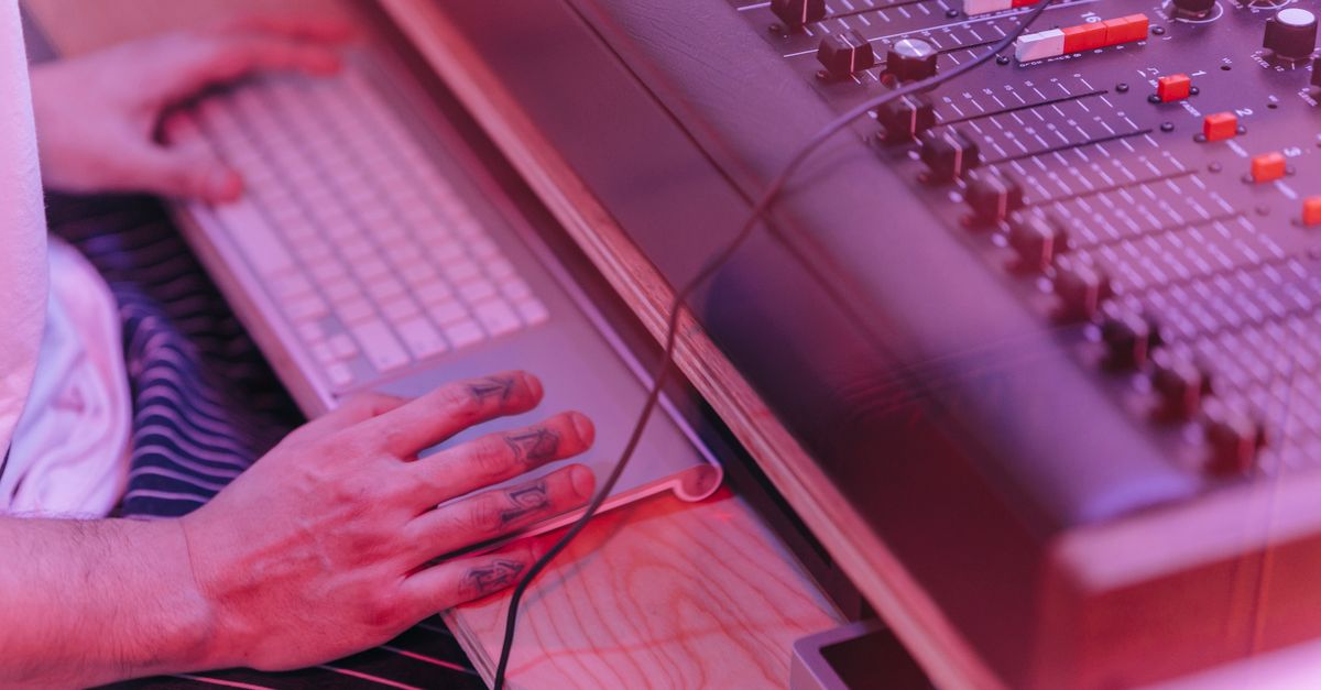 music producer working in a modern recording studio with digital charts on screen
