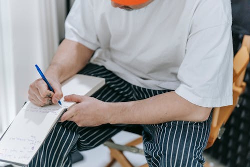 Foto profissional grátis de bloco de anotações, caneta, escrevendo