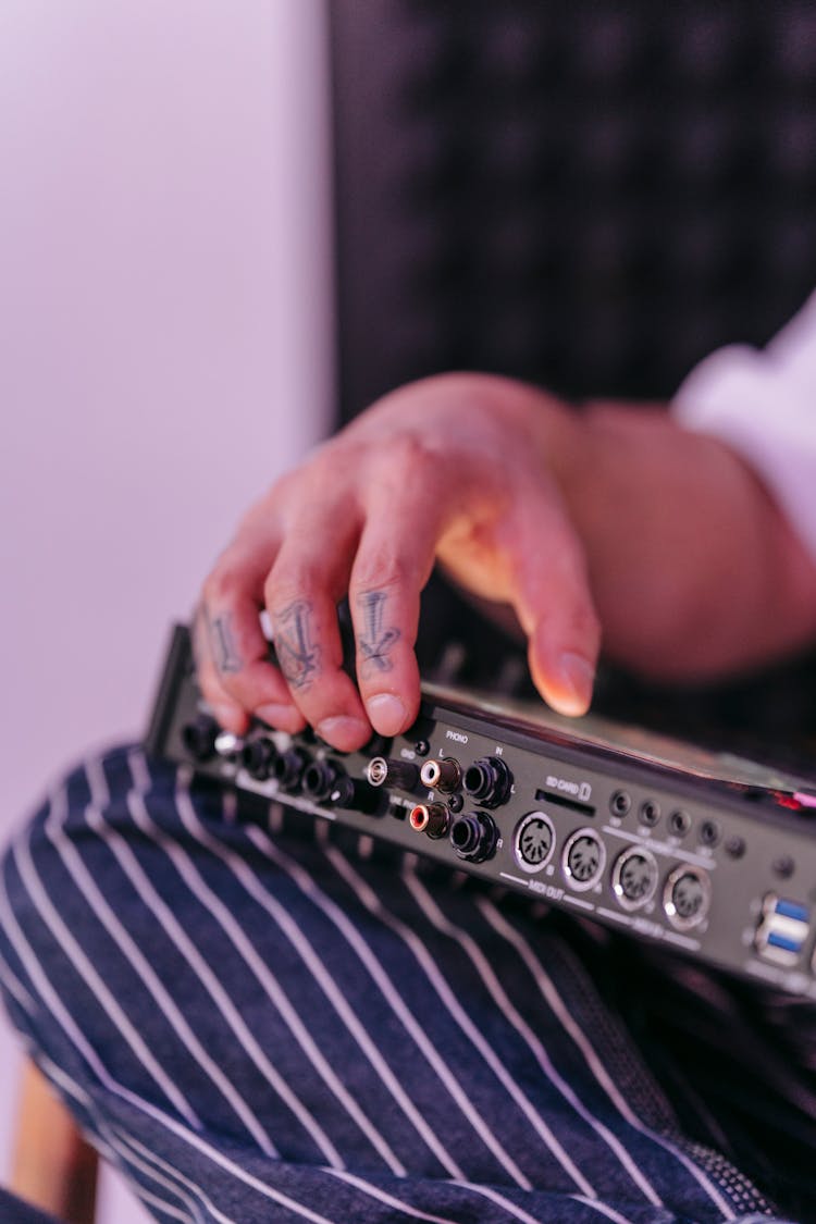 A Man Holding A Drum Machine