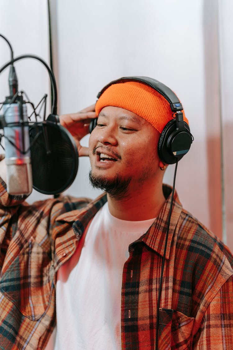 Man In Headphones Singing In Microphone