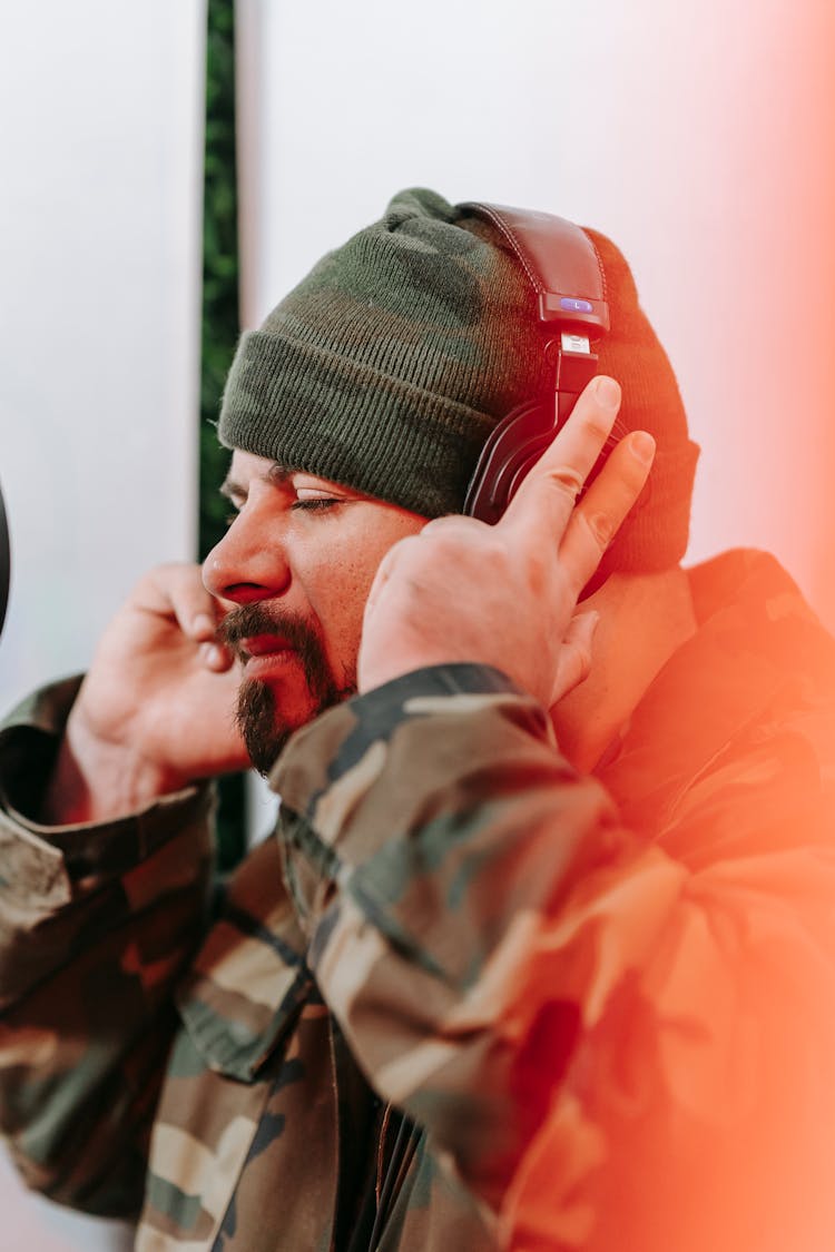 Man Listening Intently To The Music In The Headphones