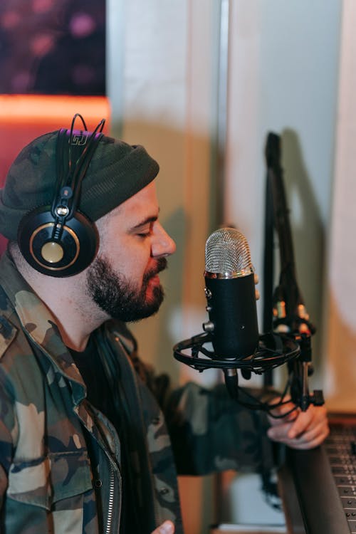 Man in Green Camouflage Jacket Singing