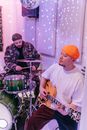 Man in White Crew Neck T-shirt Playing Green and Brown Acoustic Guitar
