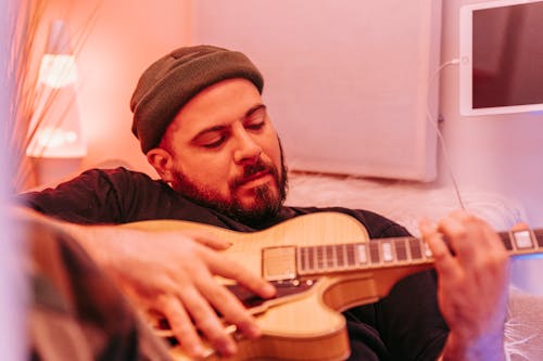 Free Man Wearing Beanie Playing Guitar  Stock Photo
