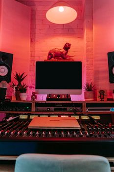 Cozy music studio with sound mixing console and ambient lighting.