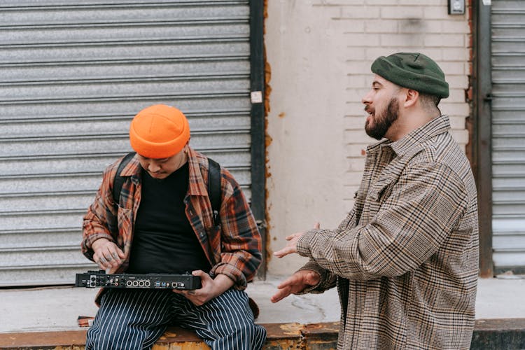 Men Mixing Music On A Little Console And Rapping On A Street 