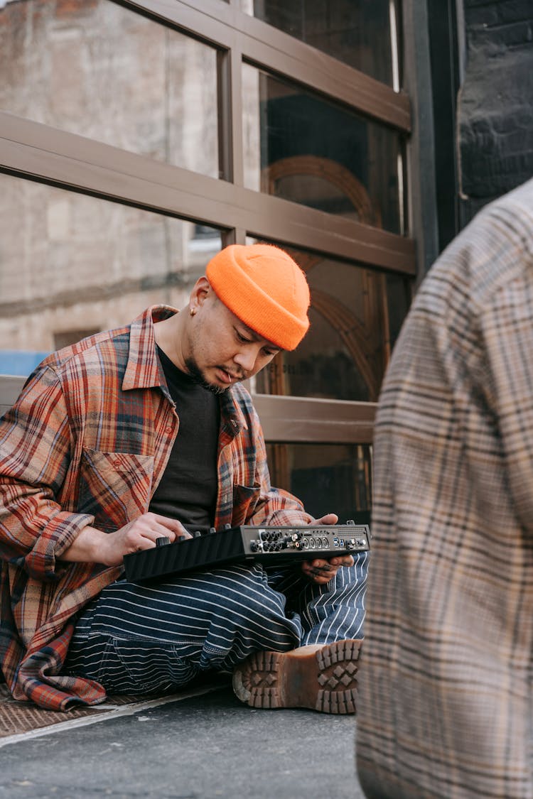 Man In Orange Beanie Playing Music