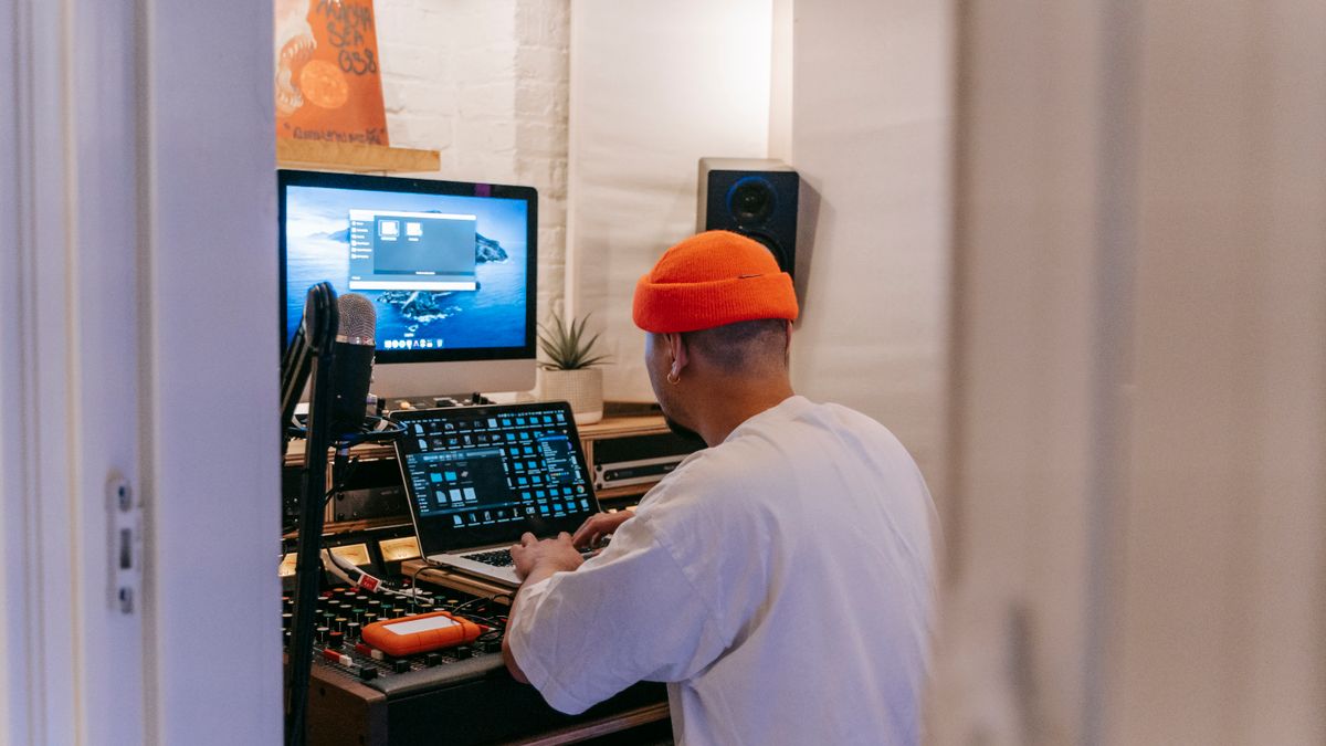 Music producer working with digital music technology in a recording studio