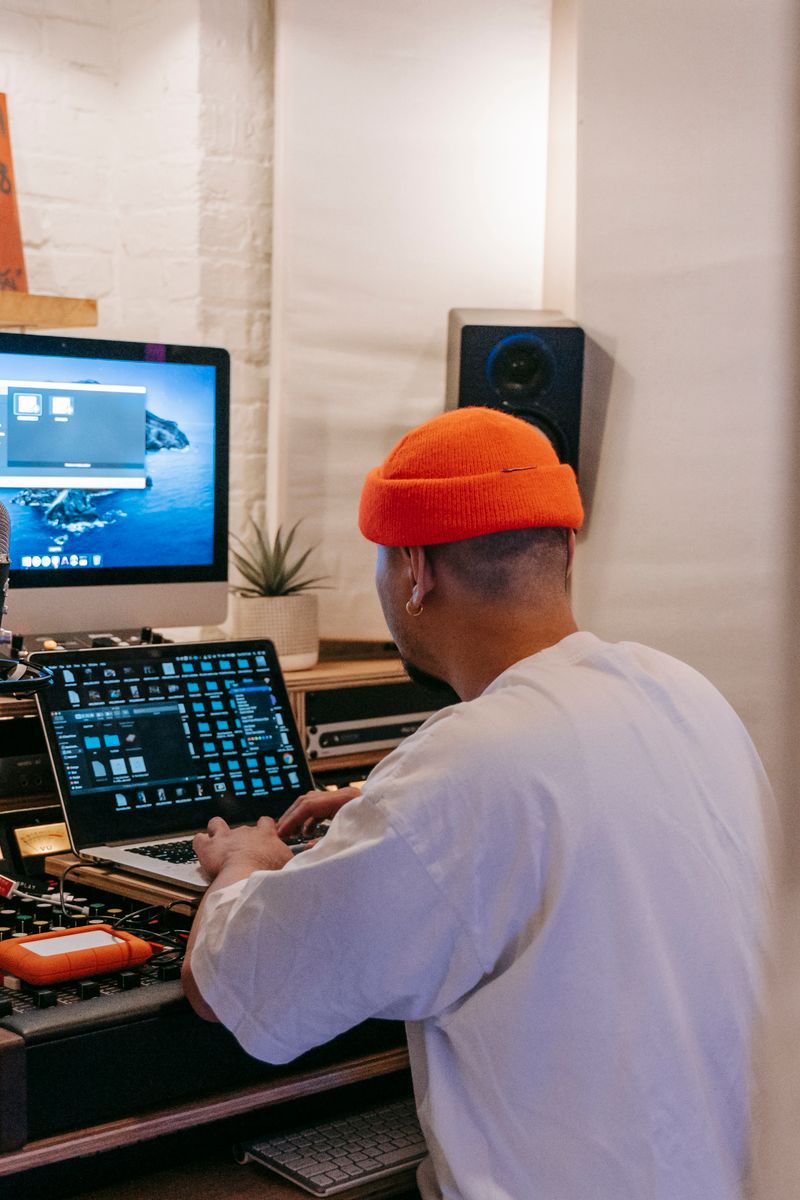 Music producer working in a studio with digital equipment