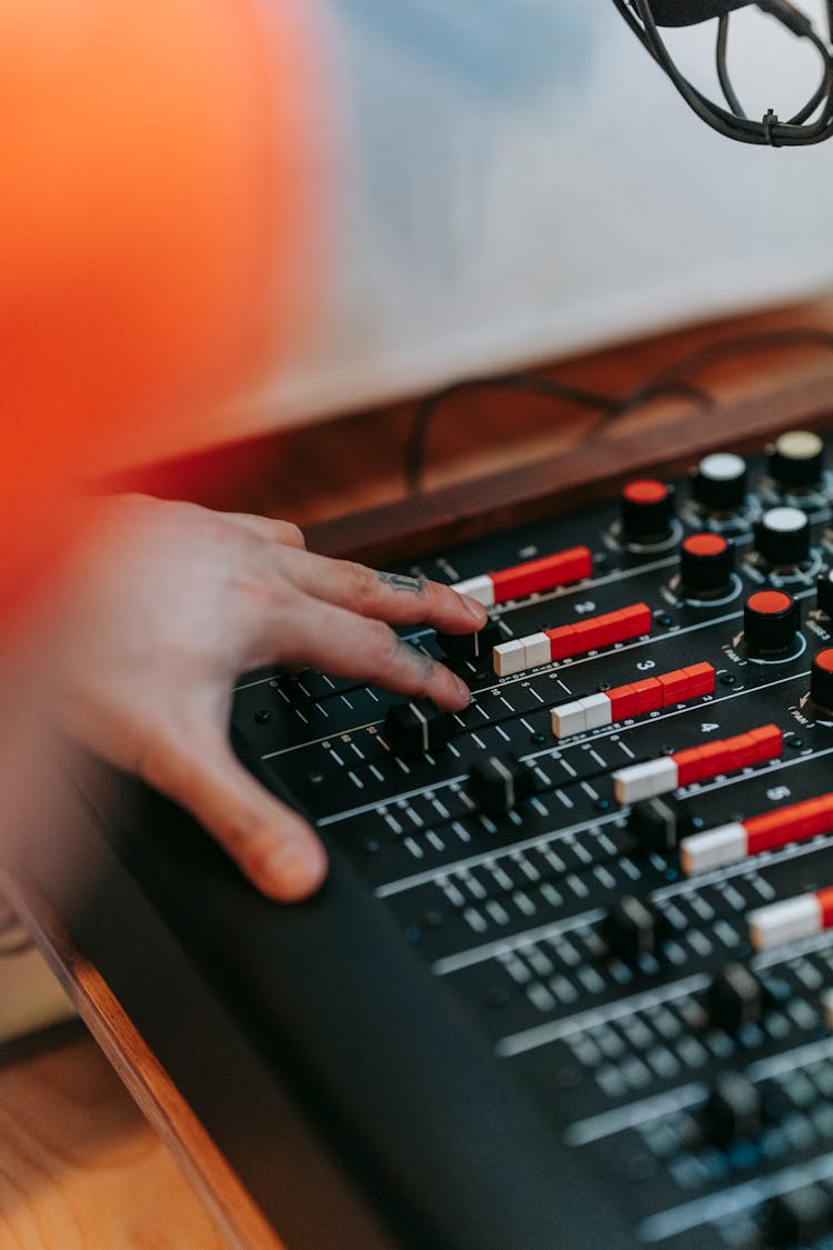 Close Up Of A Mans Hand Touching A Sound Mixer