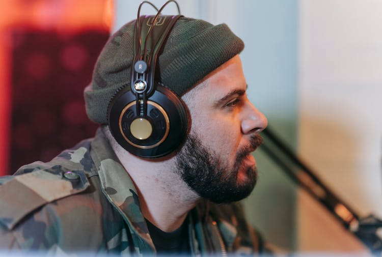 A Man In A Camouflage Print Wearing Headphones