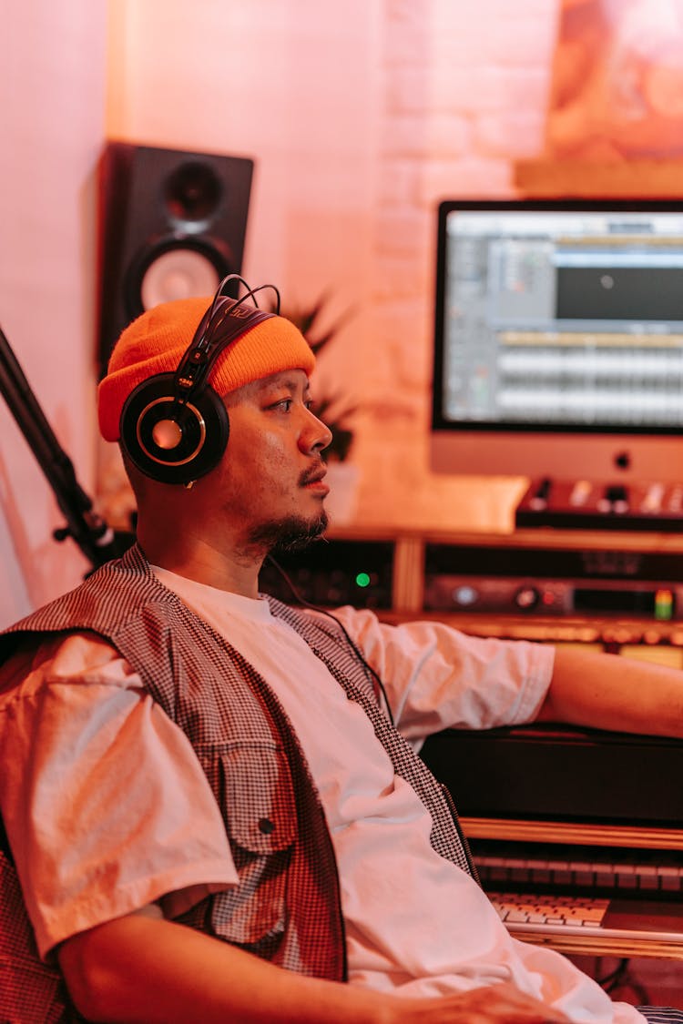 Man In Headphones Sitting In Music Studio