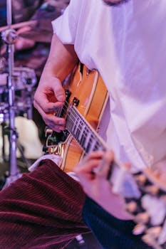 Vibrant close-up of a musician passionately playing an electric guitar during a live performance.