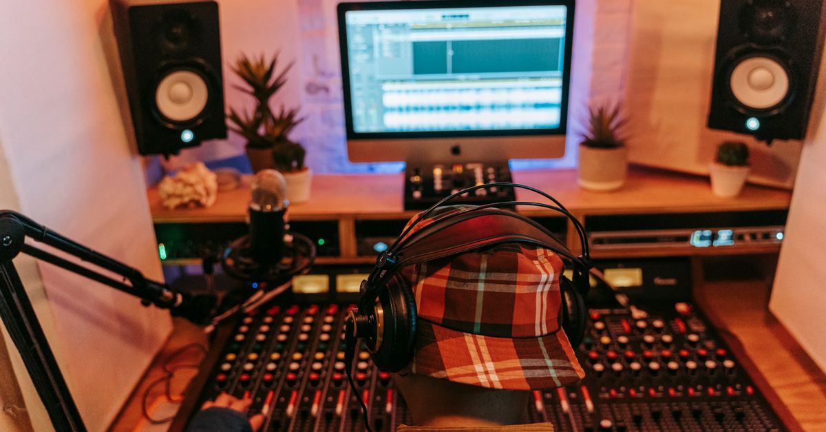 young Ghanaian music producer in a small studio with repurposed equipment, focused on mixing