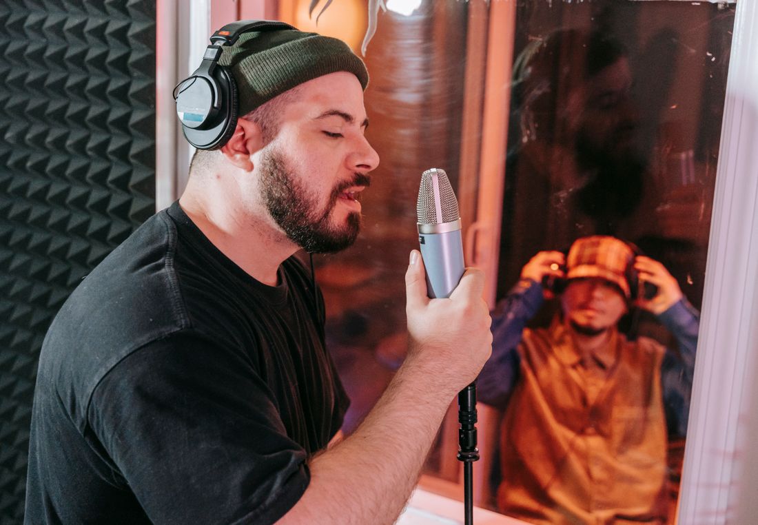Singer recording into a microphone