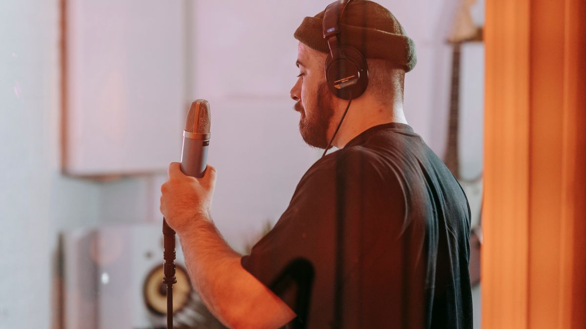 Singer recording vocals in a professional music studio