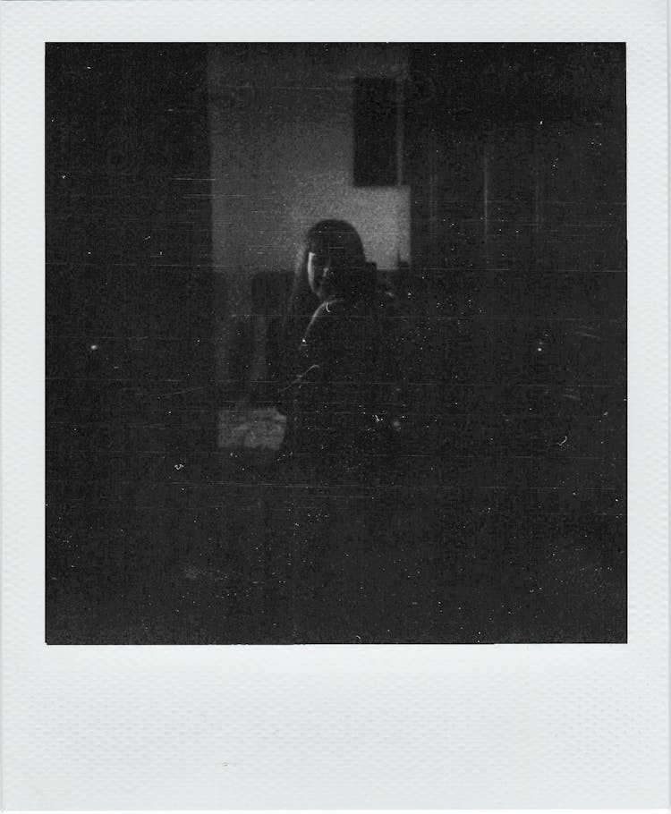 Unrecognizable Woman With Long Hair In Dark Room