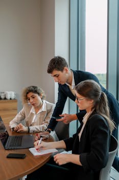 Group of young professionals working together in a modern office setting, focused on business growth.