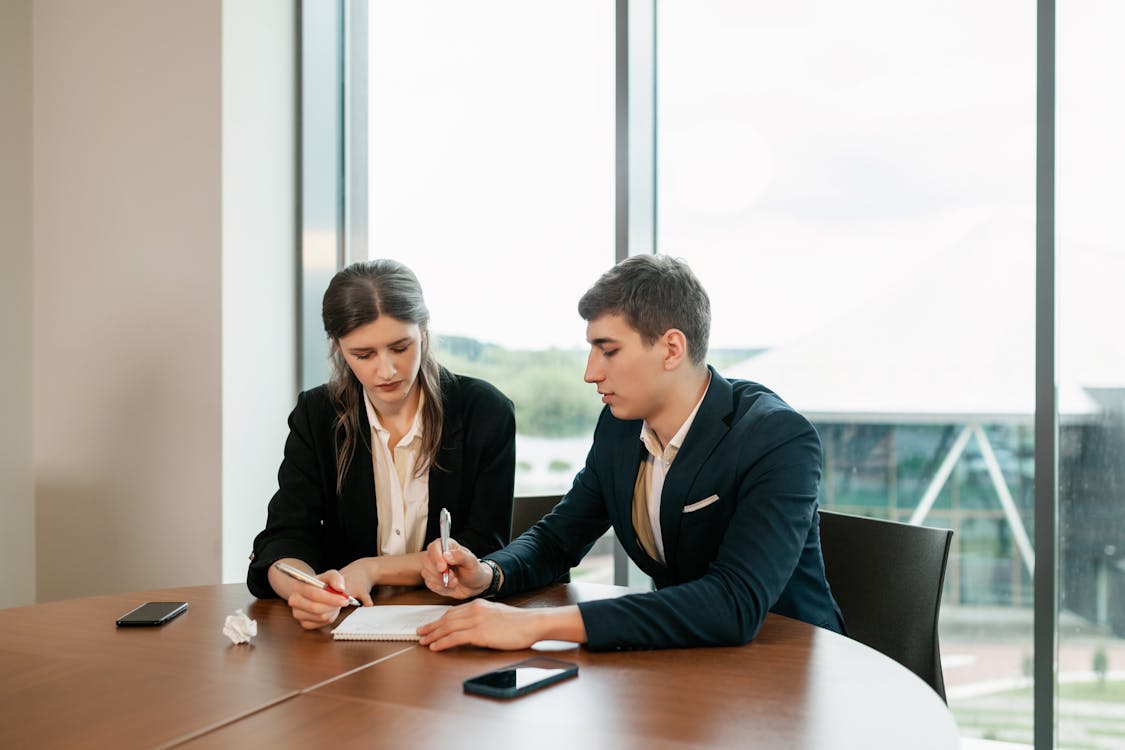 Man and woman in signing a business contract in an office