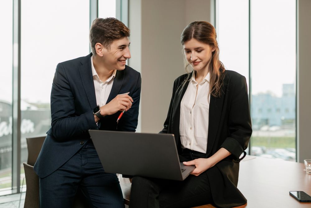 Colleagues reviewing work together around a laptop — photo by Alena Darmel on Pexels