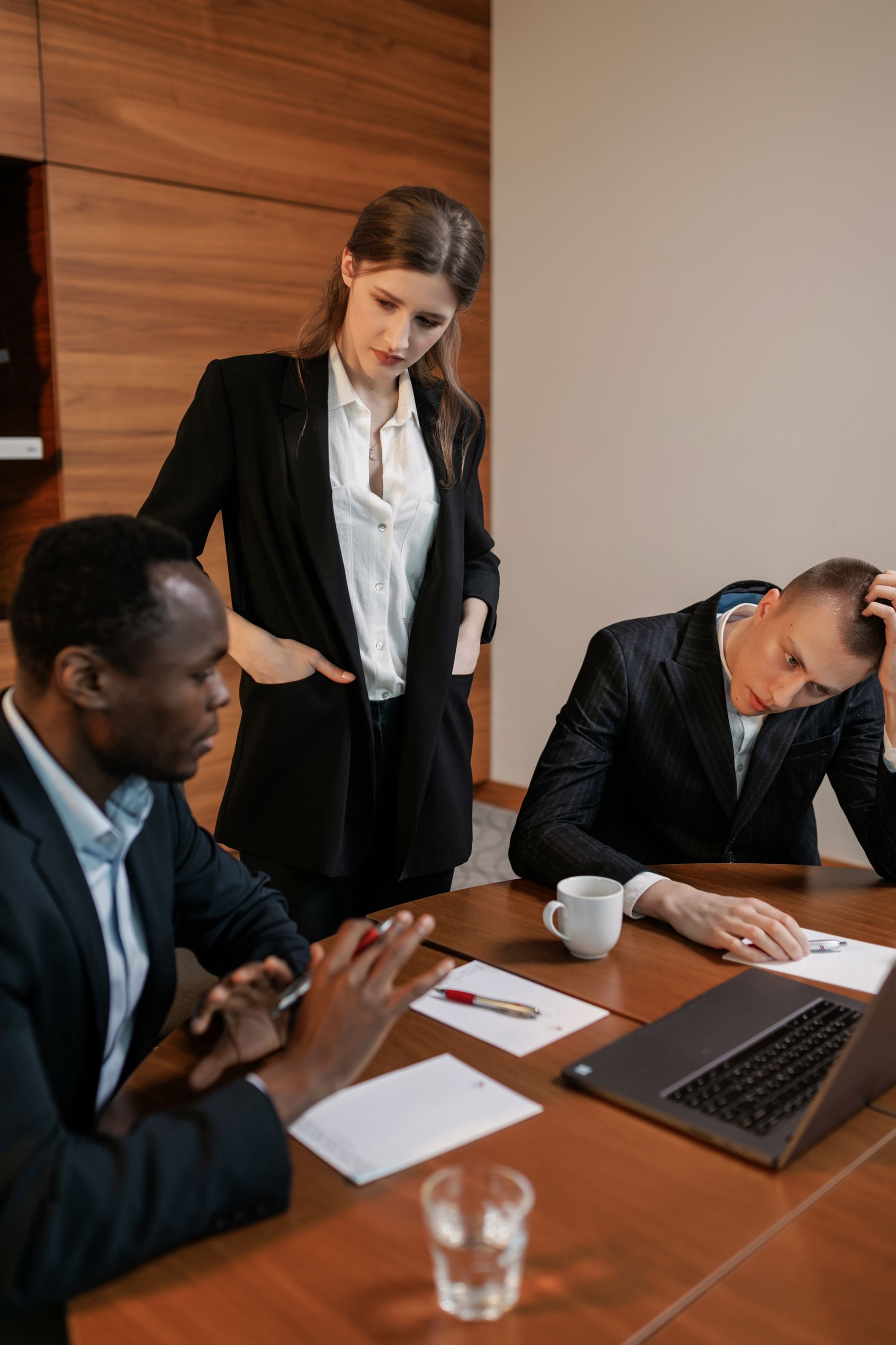 Business team collaborating around a laptop during a marketing strategy meeting