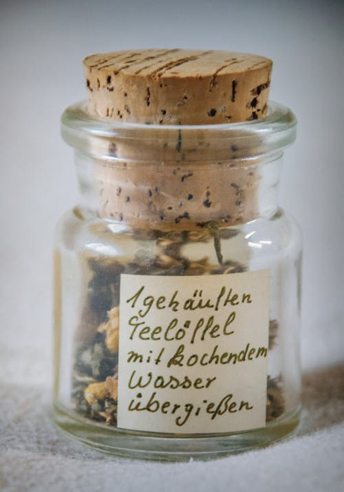 Paper Inside Clear Glass Jar With Brown Cork